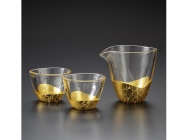 A sake server and a pair of sake glasses - gold leaf